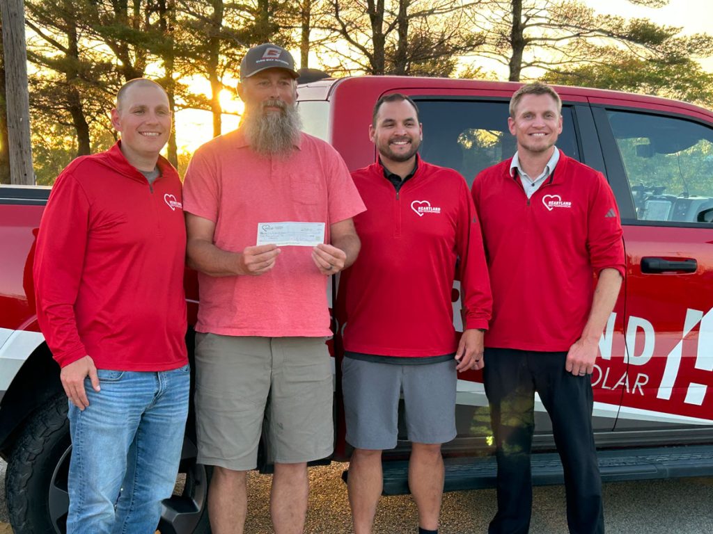 Heartland team with the recipient of a giveaway
